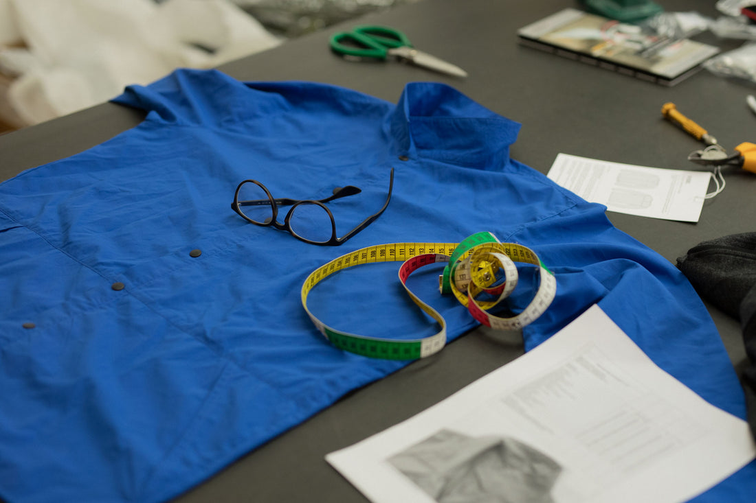 Shirt laying on table with measuring tape