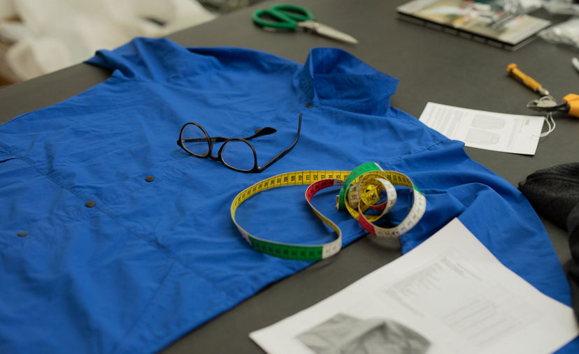 Shirt laying on table with measuring tape